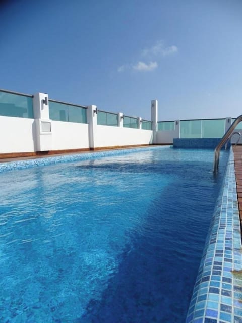 Float peacefully in clear blue water under open skies.