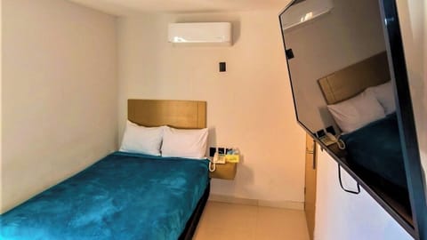 Relax in bed and enjoy easy viewing on the wall-mounted TV.