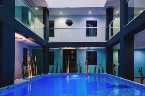 Float peacefully in a modern courtyard pool framed by balconies.