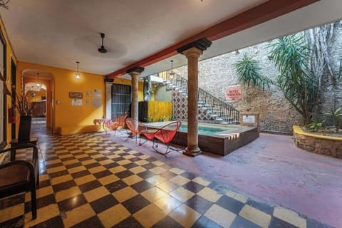 Stroll the checkered arcade and savor the breezy courtyard calm.