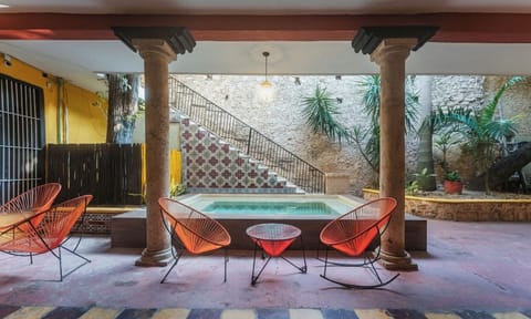 Unwind in colorful lounge chairs beside the refreshing plunge pool.