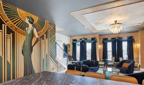 Stylish living room with plush seating, statement chandelier, and open-concept layout.