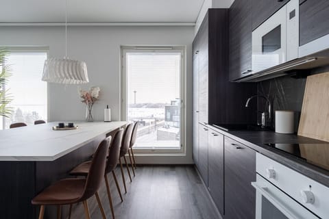 Our sophisticated charcoal kitchen features premium integrated appliances and a stunning stone-effect backsplash, blending style with functionality.