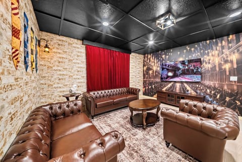 Relax in our cozy lounge with inviting brown leather sofas, warm dim lighting, and charming exposed brick walls. The bold red drapes add character, creating the perfect atmosphere for gathering with friends.
