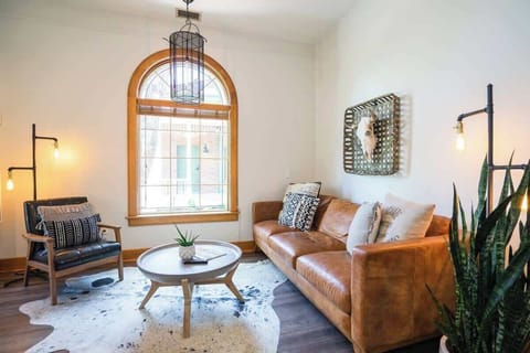 The living area is a comfortable, stylish area that includes a couch, chair and fireplace.