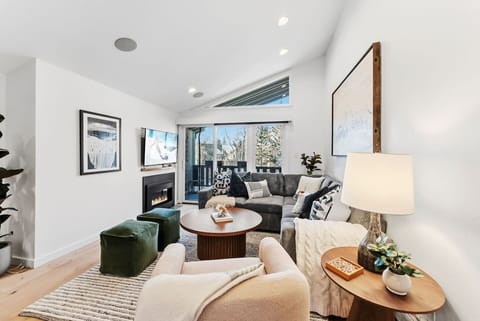 Beautifully renovated living room with fireplace, smart TV, a walkout patio and plenty of natural light