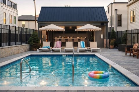 Heated resort-style pool with expansive lounge space in a private, gated setting