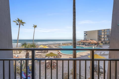 Soak in stunning ocean views from your private balcony at this oceanfront beach stay. Overlooking the resort-style pool and sandy shoreline, this vacation rental offers the perfect blend of relaxation and seaside fun.