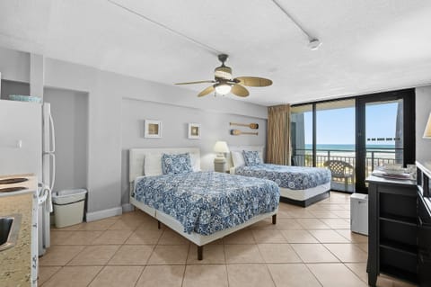 Relax in this bright beach stay studio featuring two cozy beds, a kitchenette, and a private balcony with ocean views. Steps from the sand, this coastal vacation rental is perfect for a comfortable and convenient seaside getaway.