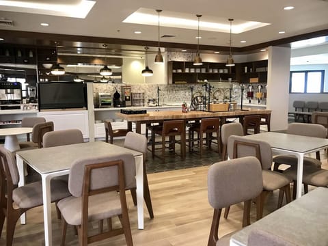 Gather for breakfast around the warm, social communal tables.