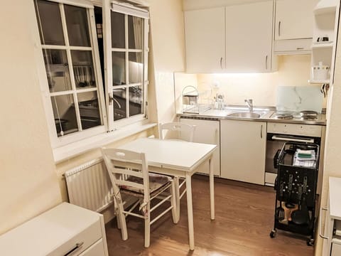 Furniture, Kitchen, Interior Design, Flooring, Floor, Major Appliance, Room, Apartment, Cabinetry, Kitchen Appliance