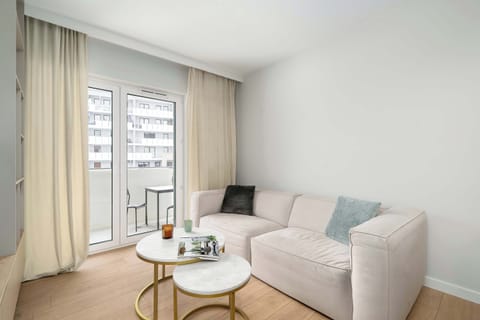 Relax in the stylish living room with a comfortable sofa and modern decor.