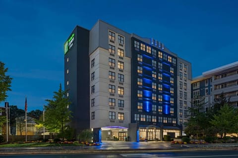 Evening view of the property with bright exterior lights