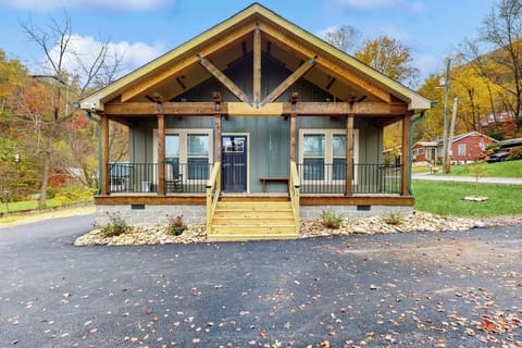 Inviting cabin entrance with spacious porch and views of the serene mountains!