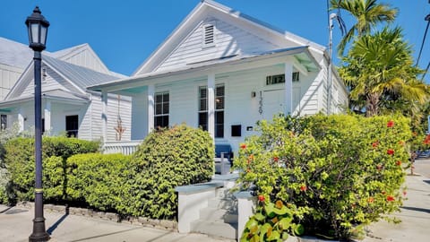 Charming coastal cottage with tropical gardens and classic architecture creates the perfect island getaway setting.