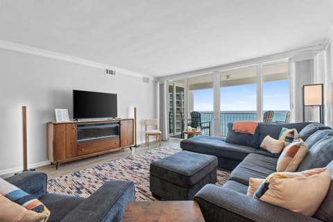 Unwind in your elegant living room with stunning ocean views through floor-to-ceiling windows. Sink into the plush sectional and enjoy your perfect coastal retreat.