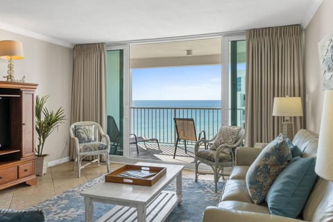 Unwind in your oceanfront living room where turquoise waters stretch endlessly beyond your private balcony and coastal breezes drift through elegant furnishings.