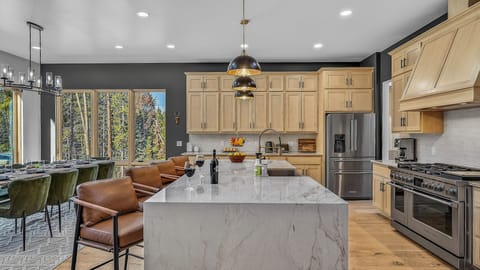 Kitchen, Main Level - Large island with bar seating and modern appliances.