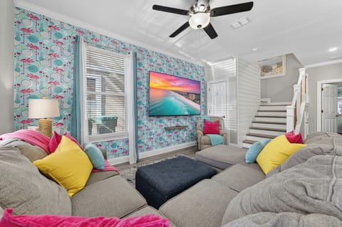 90" Movie theatre screen in living room. Large couch and seating for everyone!