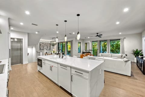 Contemporary finishes and an oversized island anchor the kitchen.