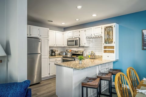 A fully equipped kitchen with granite countertops and bar seating, perfect for easy meals and casual gatherings.