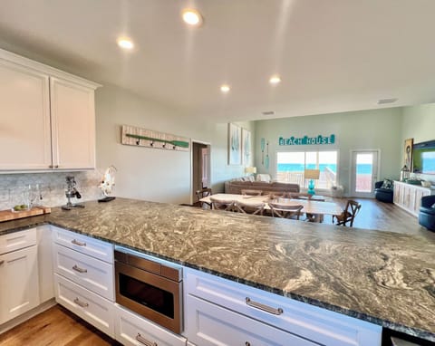 The kitchen features stone counters and stainless steel appliances