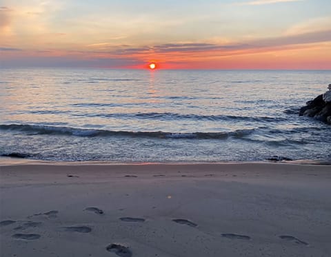 Enjoy calm evening walks along our beach as the sun sets over Lake Michigan.