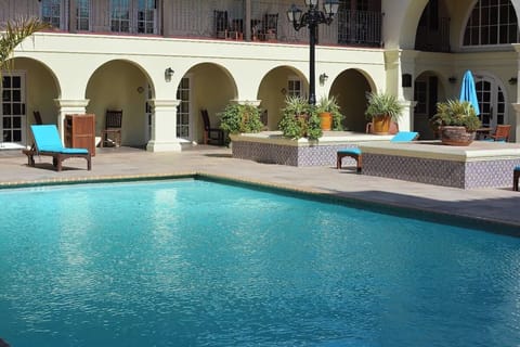 Float in sparkling water steps from shaded arcades and loungers.