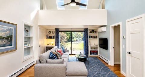 Bright, airy living space with soaring ceilings and down filled sofa and chaise.