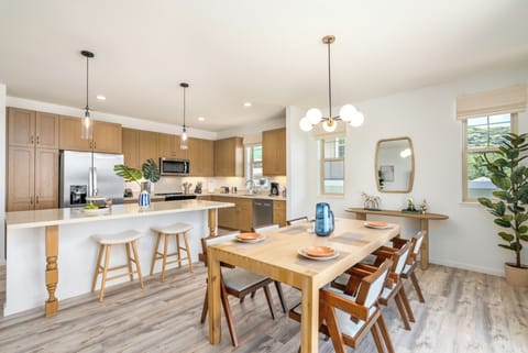 The dining table for six sits right in front of the well-equipped luxury kitchen