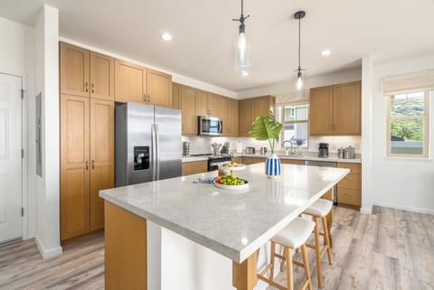 Floor-to-ceiling cabinetry provides ample storage, with big stone countertops.