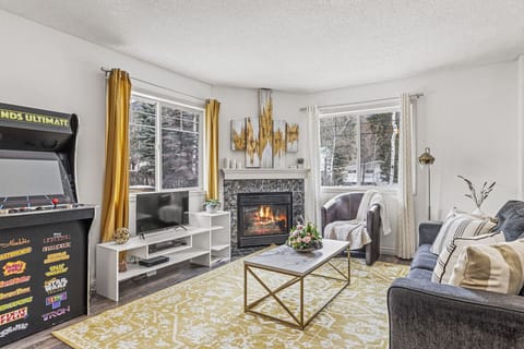 Enjoy your favorite movies in this cozy living room with a fireplace.