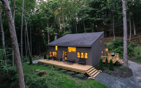 Modern forest retreat with a spacious deck and peaceful wooded views