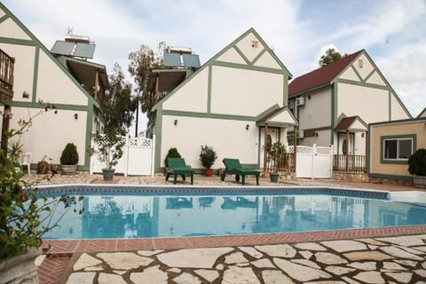 ERV Club Villas exterior with shared pool area in Livadi
