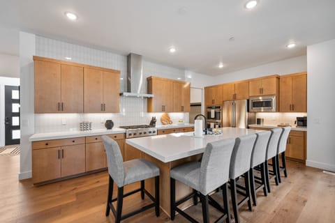 A fully equipped chefs kitchen with massive kitchen island, tons of seating and just about every amenity you can think of