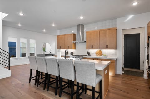 A fully equipped chefs kitchen with massive kitchen island, tons of seating and just about every amenity you can think of