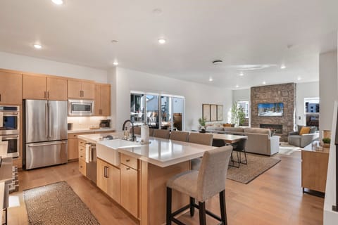A fully equipped chefs kitchen with massive kitchen island, tons of seating and just about every amenity you can think of