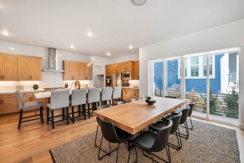 An oversized Dining room with seating for 10 at the table and another 6 at the kitchen island