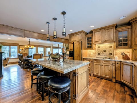 Your gourmet kitchen features rich wood cabinetry, granite counters, and a spacious island perfect for cooking memorable meals together.