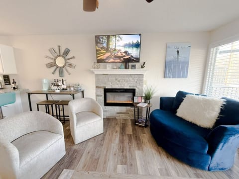 Modern coastal living room with cozy fireplace, stylish décor, and bright natural lighting — perfect for relaxing or entertaining.