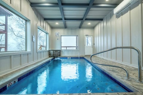 Dive into your private indoor pool sanctuary, where crystal-clear waters await beneath soaring beams and natural light streaming through windows.