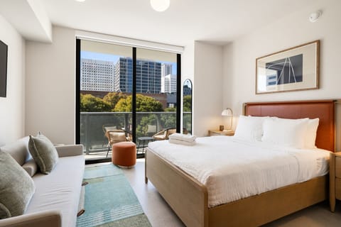 Bright bedroom with balcony access and city views 🌆