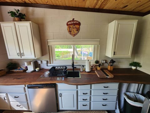 Enjoy preparing meals in a thoughtfully designed kitchen with a cozy wooden ceiling and a warm natural feel