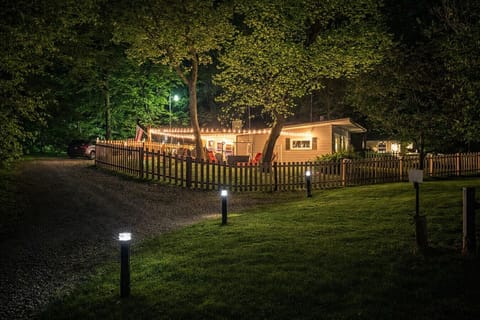 A gently lit cabin nestled in nature offers quiet evenings, relaxing nights, and a comforting welcome after a full day of adventure.