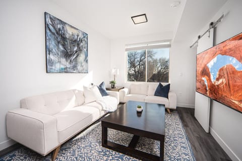 Beautifully designed living room. 65` TV, comfy  sofa and loveseat, amazing views of mountains.