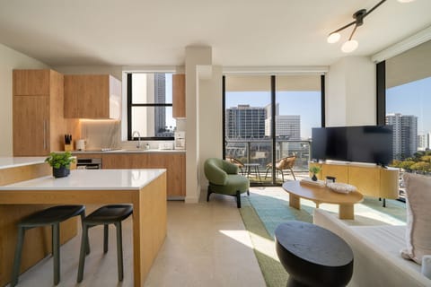 Bright open living and kitchen space with city views