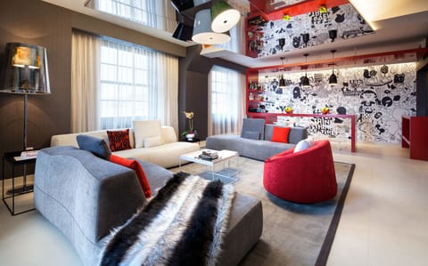 Gather in the vibrant lounge for cocktails and conversation.