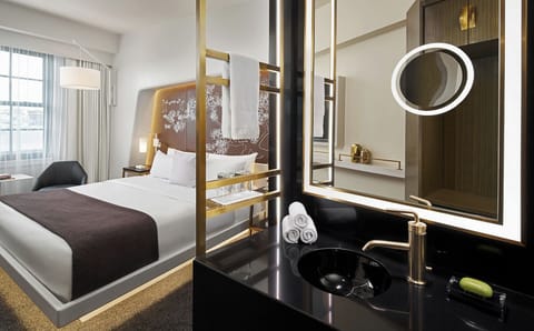 Unwind in a sleek suite with spa-style vanity glow.
