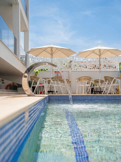 Seasonal outdoor pool, open 9:00 AM to 9:00 PM, pool umbrellas