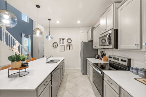 Experience culinary delight in this modern kitchen with a spacious island and chic decor, perfect for entertaining.